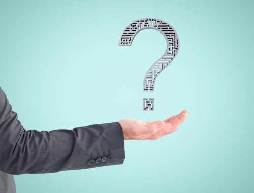 composite of hand holding questionmark graphic with blue background